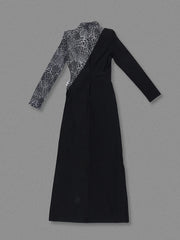 Black dress with patterned long-sleeve top on a gray background