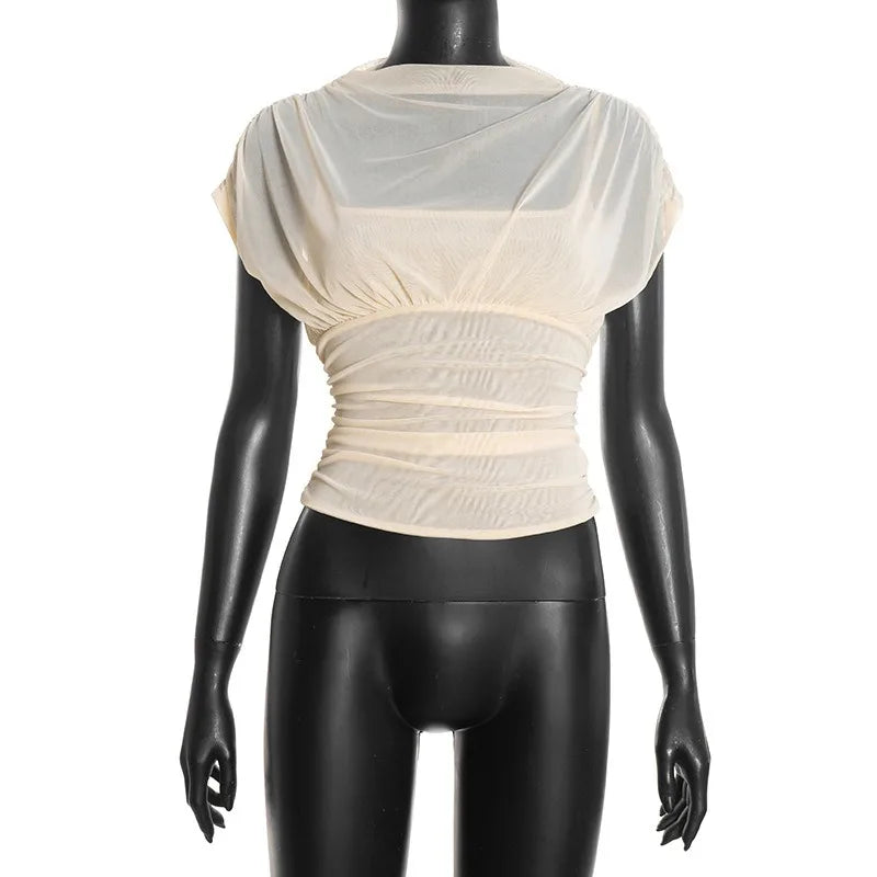 Mannequin wearing a cream-colored top with sheer overlay on a white background