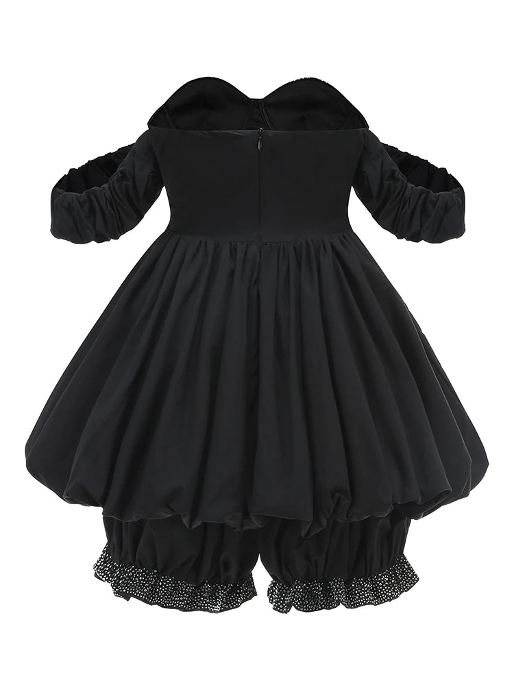 Black dress with long sleeves and ruffled bottom on a white background