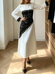 Side view of a black lace panel long sleeve midi dress.