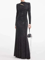 Black sequin evening gown with long sleeves on a white background