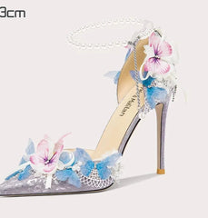 High-heeled shoe with floral design on a white background