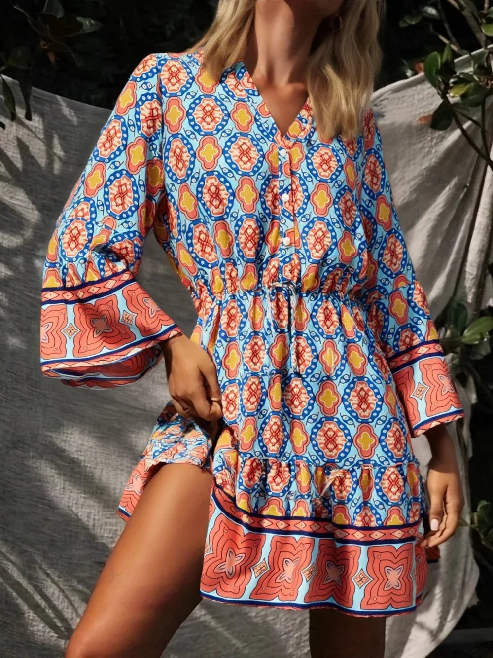 Mini dress with geometric print, V-neck, and flare sleeves