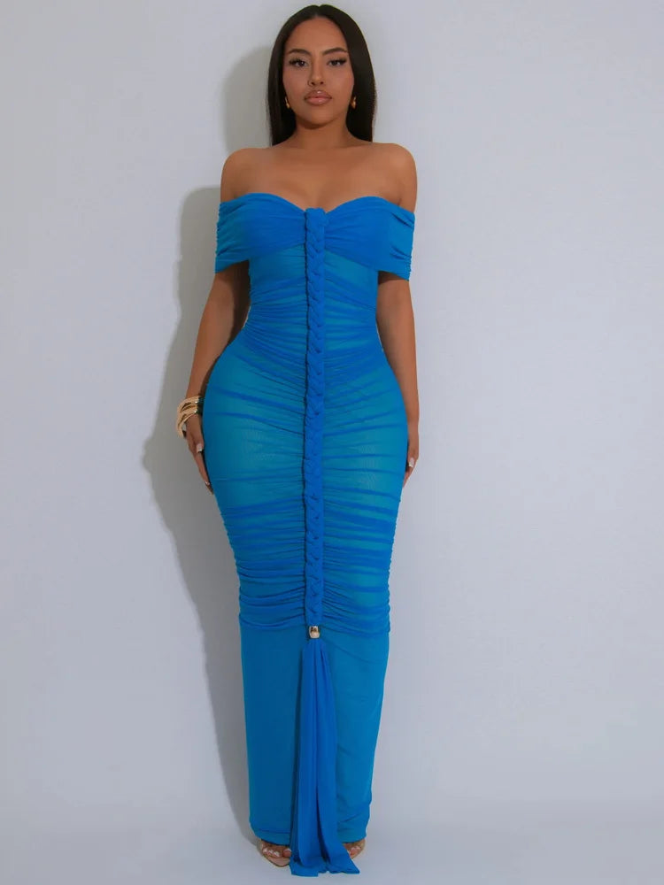 Woman wearing a blue off-shoulder dress against a white background