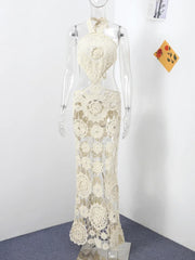 White lace dress on a mannequin against a white wall.