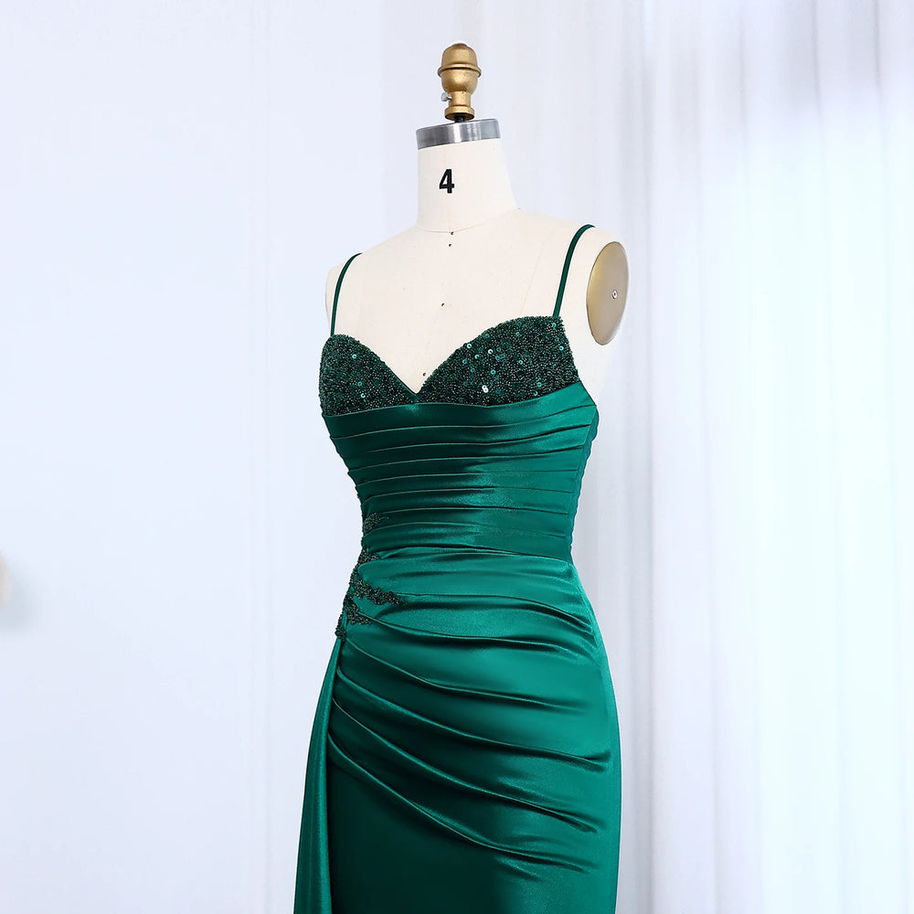 Green evening gown on a mannequin against a white background