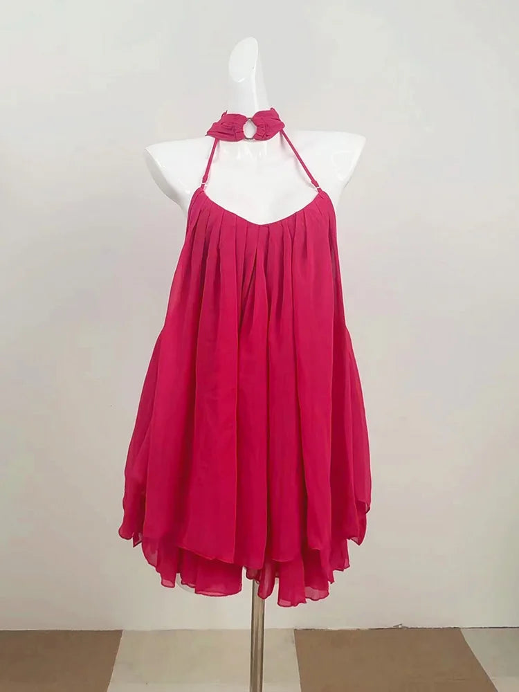 Rose red dress on a mannequin against a plain background