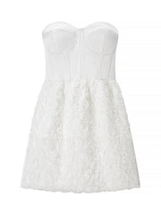 White strapless dress with floral lace details on a white background