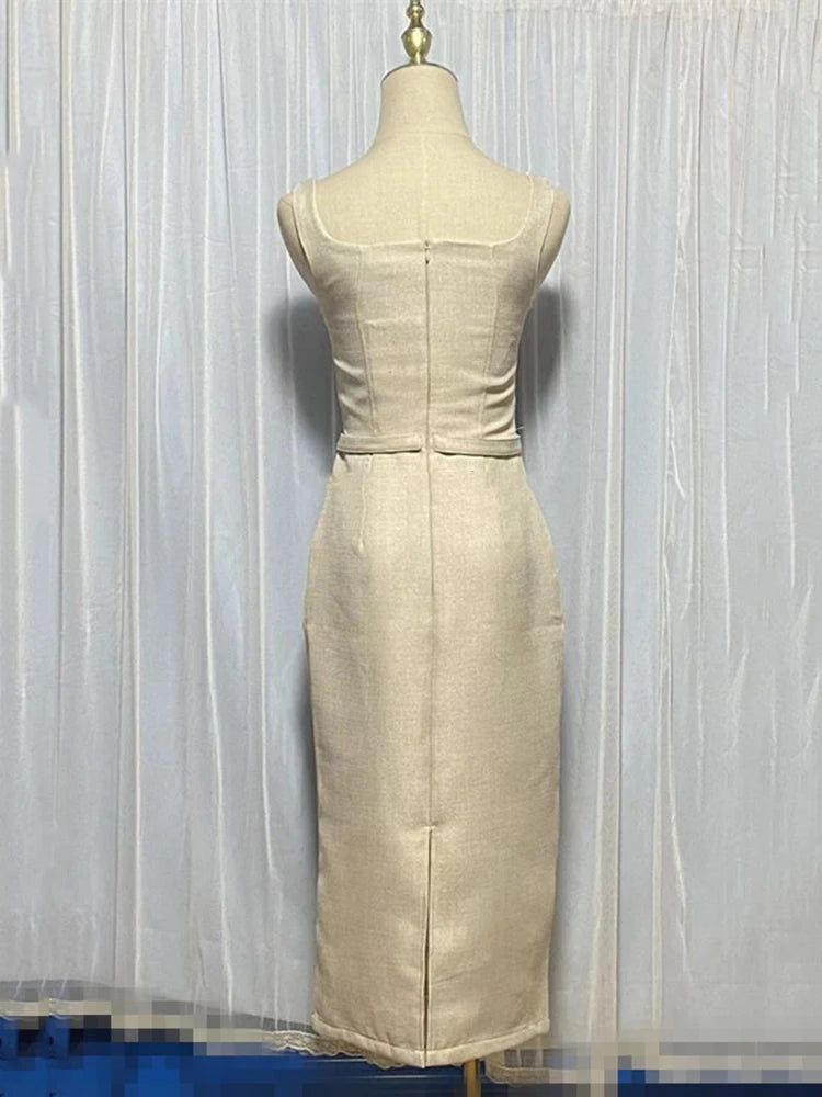 Beige dress on a mannequin against a white curtain background