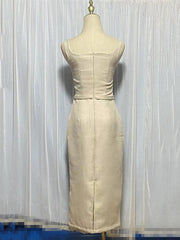 Beige dress on a mannequin against a white curtain background