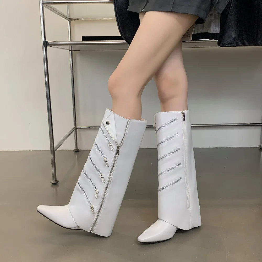 White knee-high boots with decorative elements on a neutral background