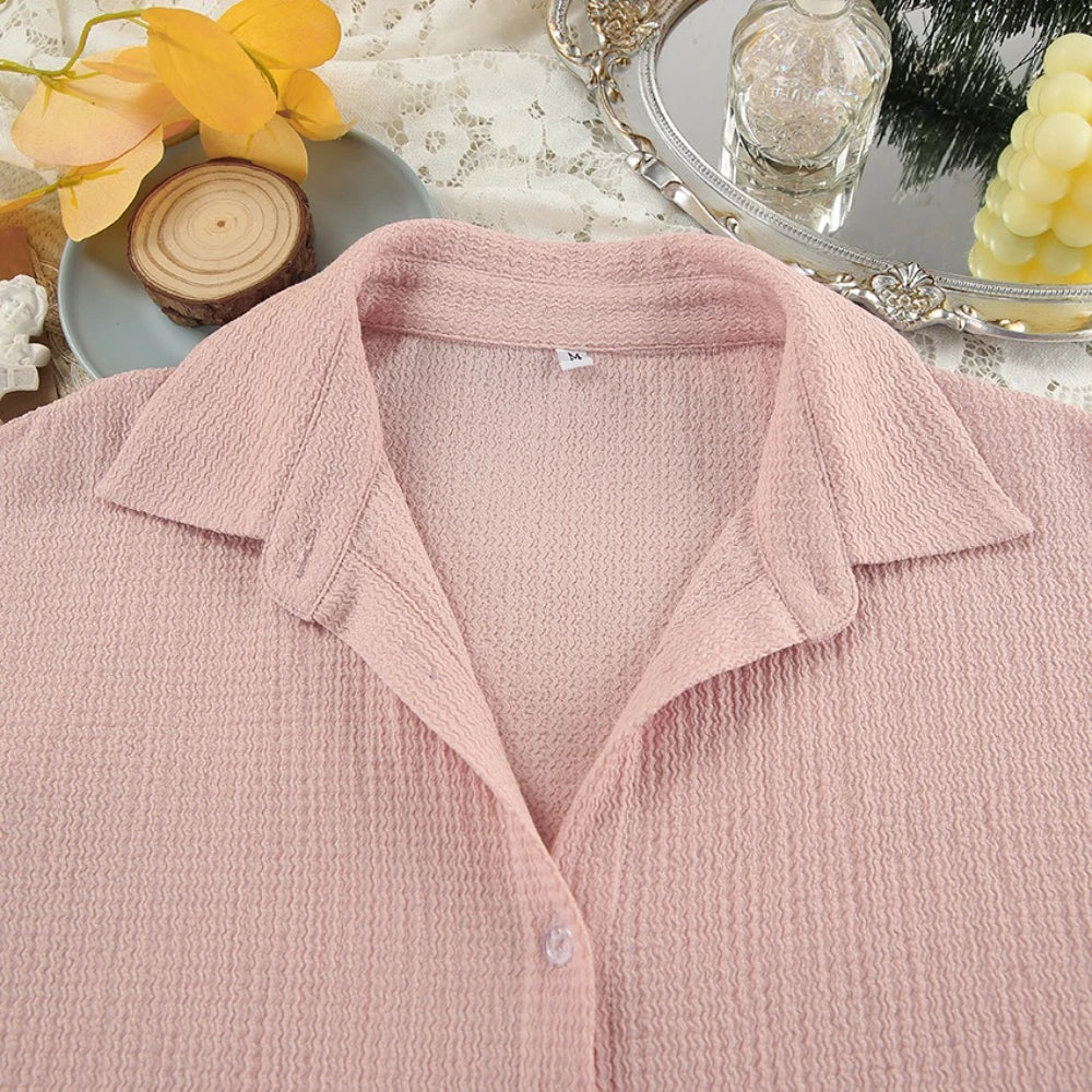 Pink textured shirt with a blurred decorative background