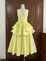 Yellow dress on a mannequin against a wooden door background