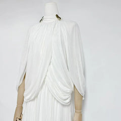 White draped garment on a mannequin against a white background