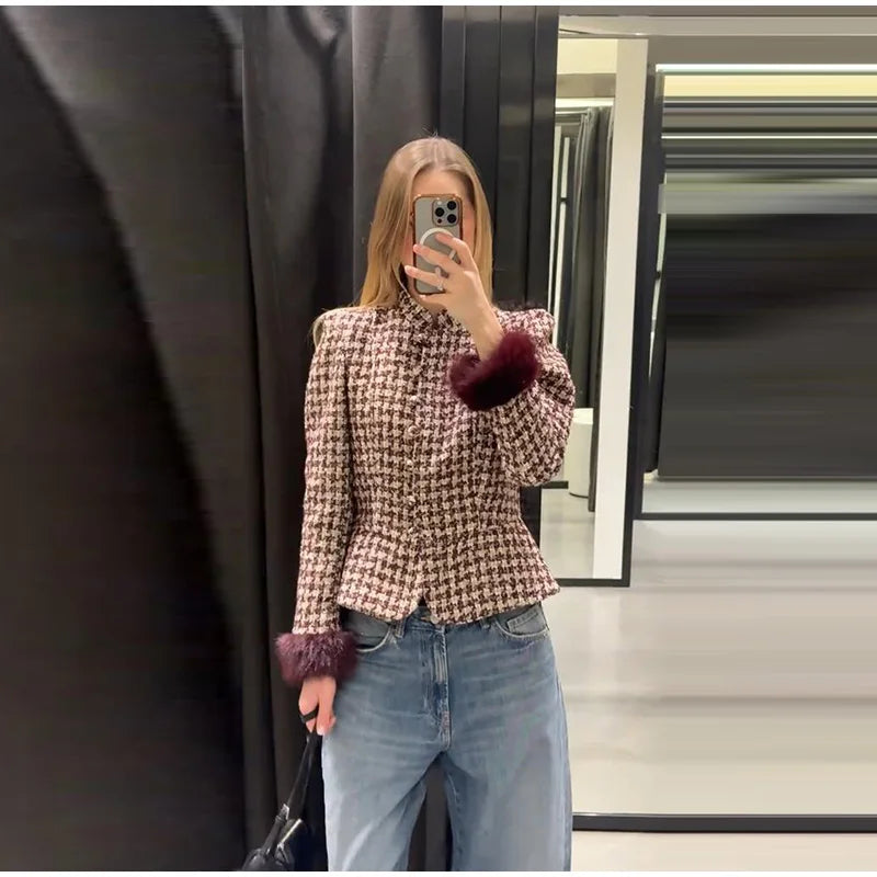 Model wearing a plaid tweed jacket with faux fur cuffs