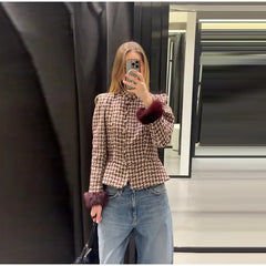 Model wearing a plaid tweed jacket with faux fur cuffs