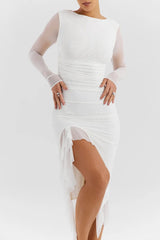White dress with sheer sleeves and a high slit