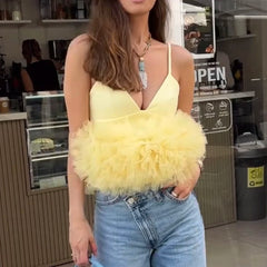 Woman holding a yellow fluffy handbag in a casual setting