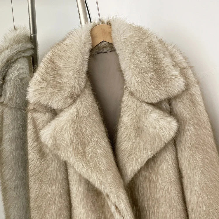 Beige fur coat on a hanger against a neutral background