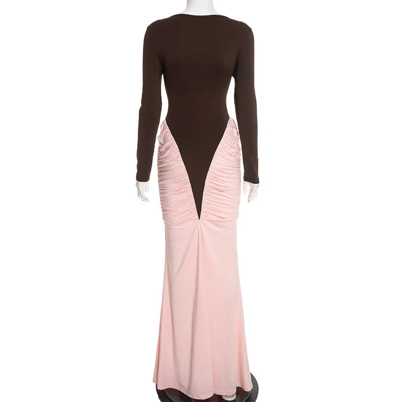 Mannequin wearing a dress with a brown top and pink skirt on a white background