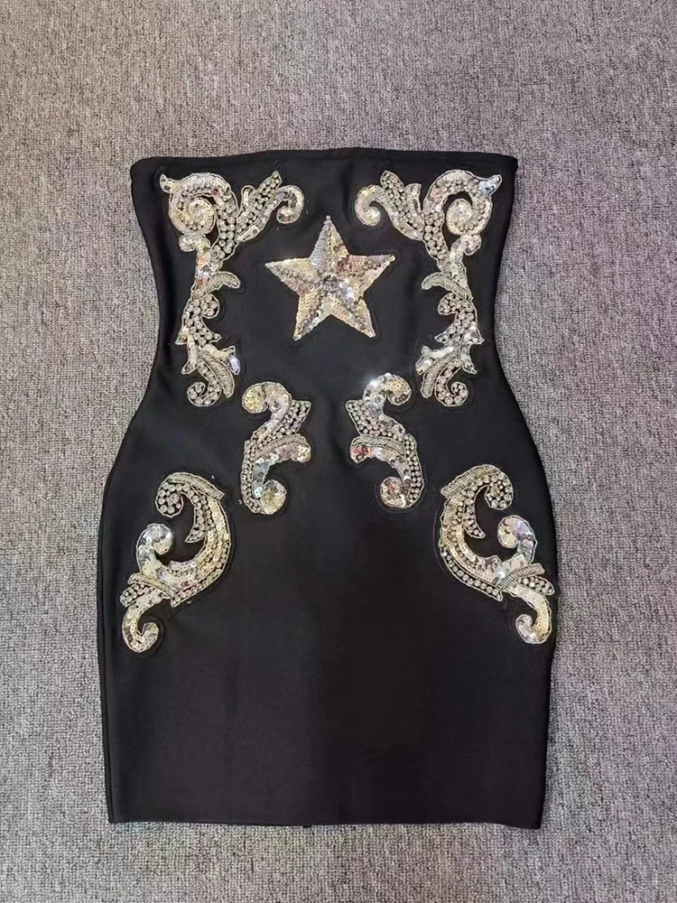 Strapless black mini dress with sequin star and scroll detail