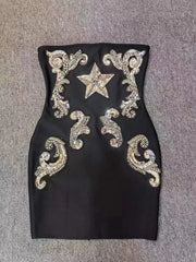Strapless black mini dress with sequin star and scroll detail