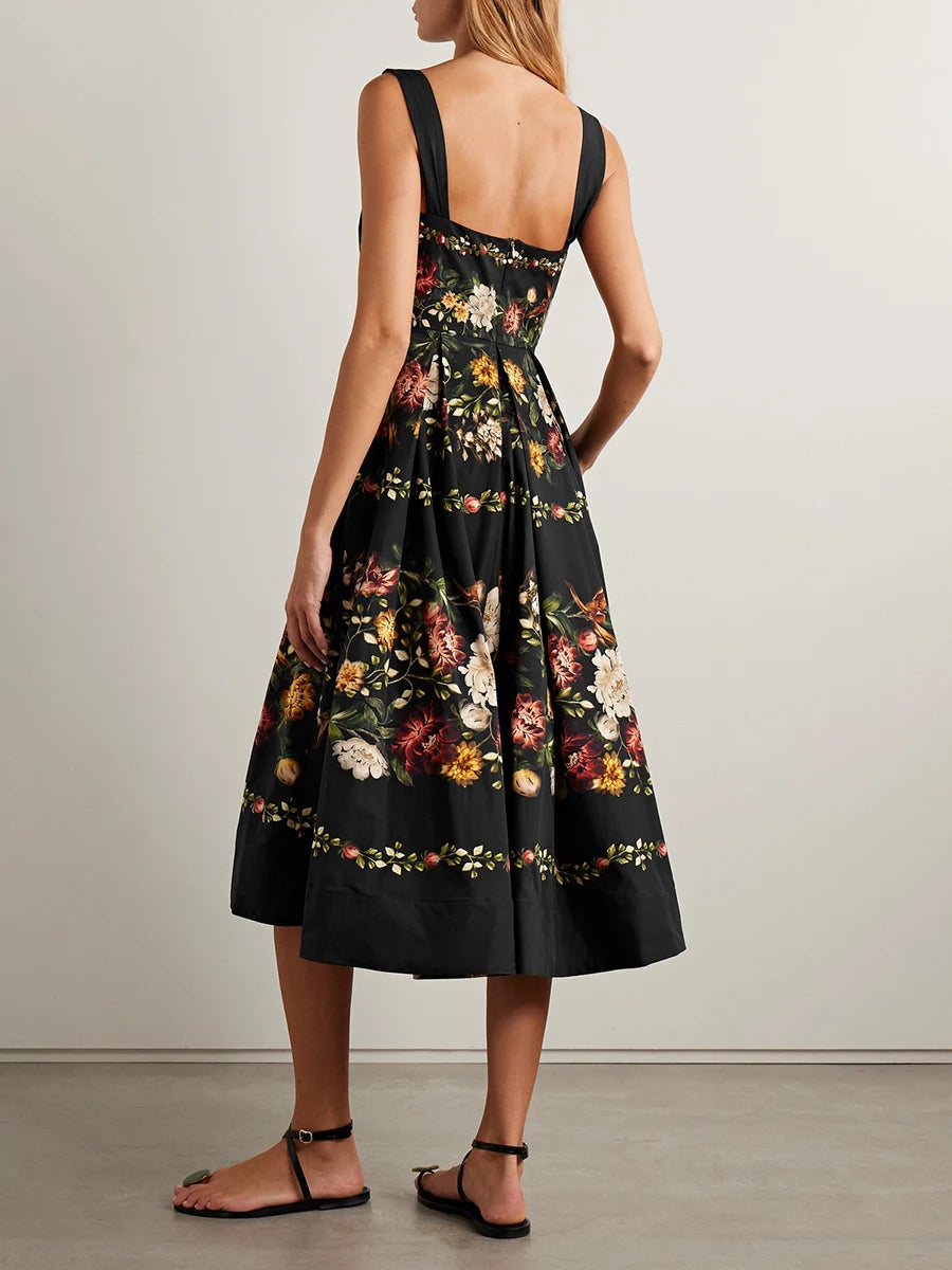 Back view of a black floral print square neck sleeveless A-line midi dress with a gathered hem.