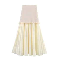 Two-tone skirt with beige top and pleated cream skirt on a white background