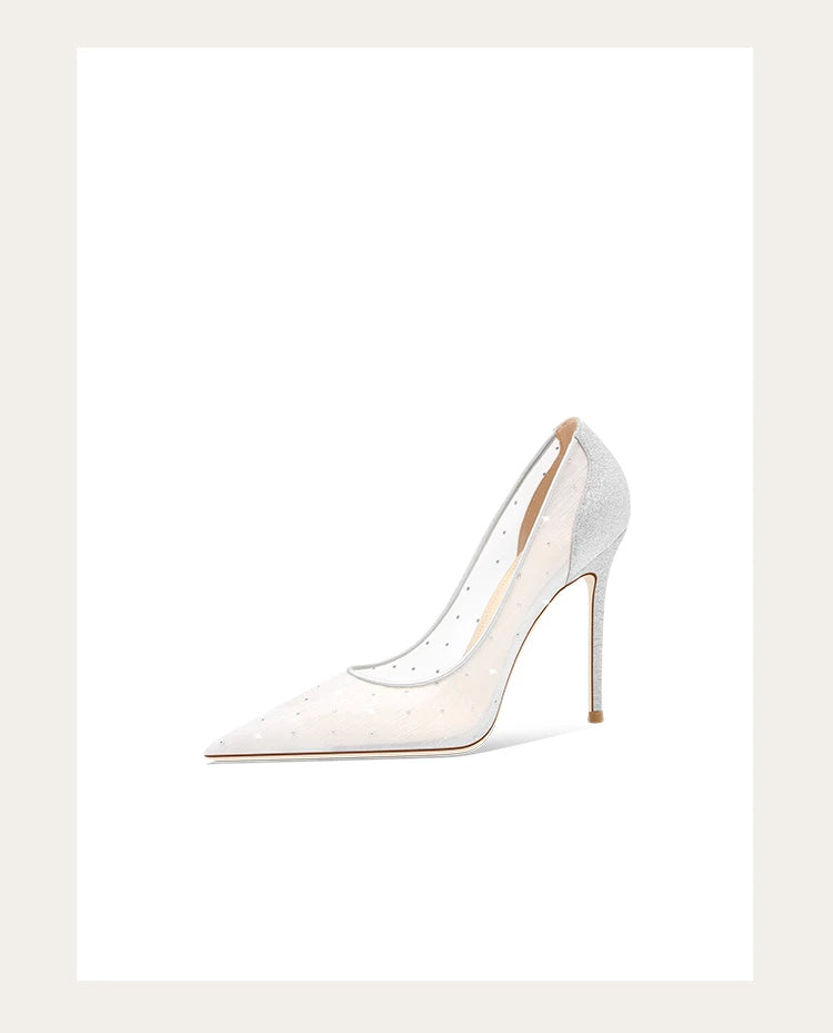 White high-heeled shoe with gold accents on a light beige background