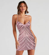 Woman wearing a patterned dress against a plain background