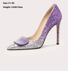 Purple glitter high heel shoe with bow detail on a light grey background