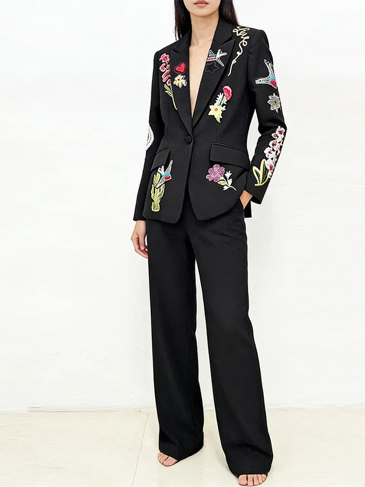 Full body shot of a model wearing the embroidered blazer and trousers suit