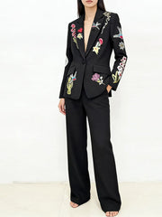Full body shot of a model wearing the embroidered blazer and trousers suit