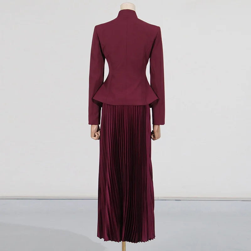 Maroon peplum jacket and pleated skirt set on a mannequin against a white background