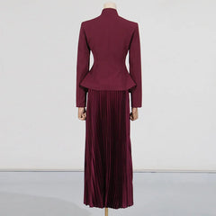 Maroon peplum jacket and pleated skirt set on a mannequin against a white background