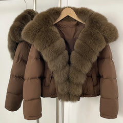 Brown puffer jacket with fur collar on a hanger against a white background