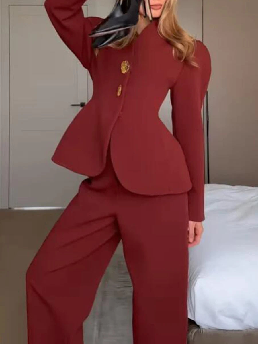 Person wearing a red suit standing in a room with a bed in the background