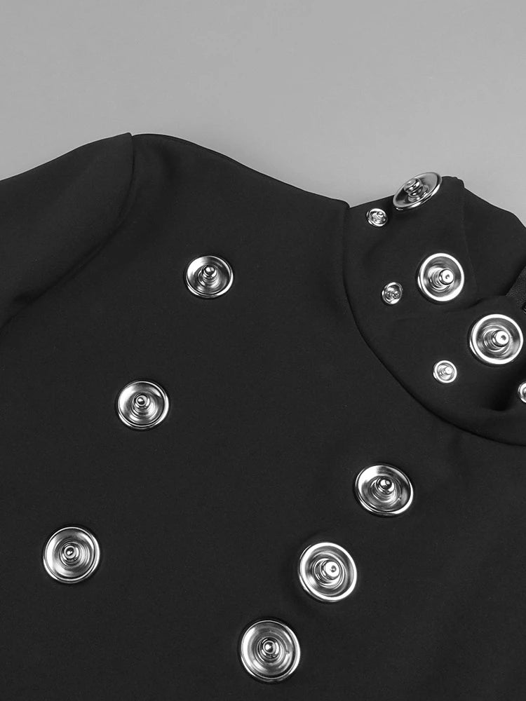 Black garment with silver buttons on a gray background