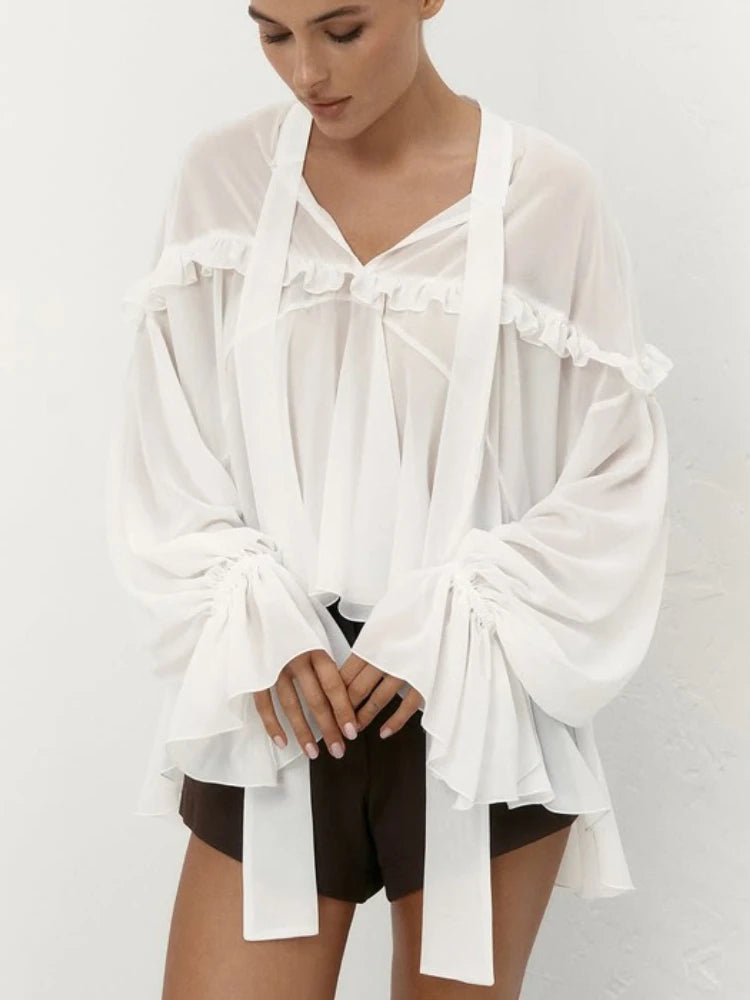 Close-up of the ruffled neckline and draped tie details