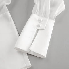 White shirt with rolled-up sleeves on a light gray background