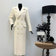 White coat on a mannequin next to a side table with decor items