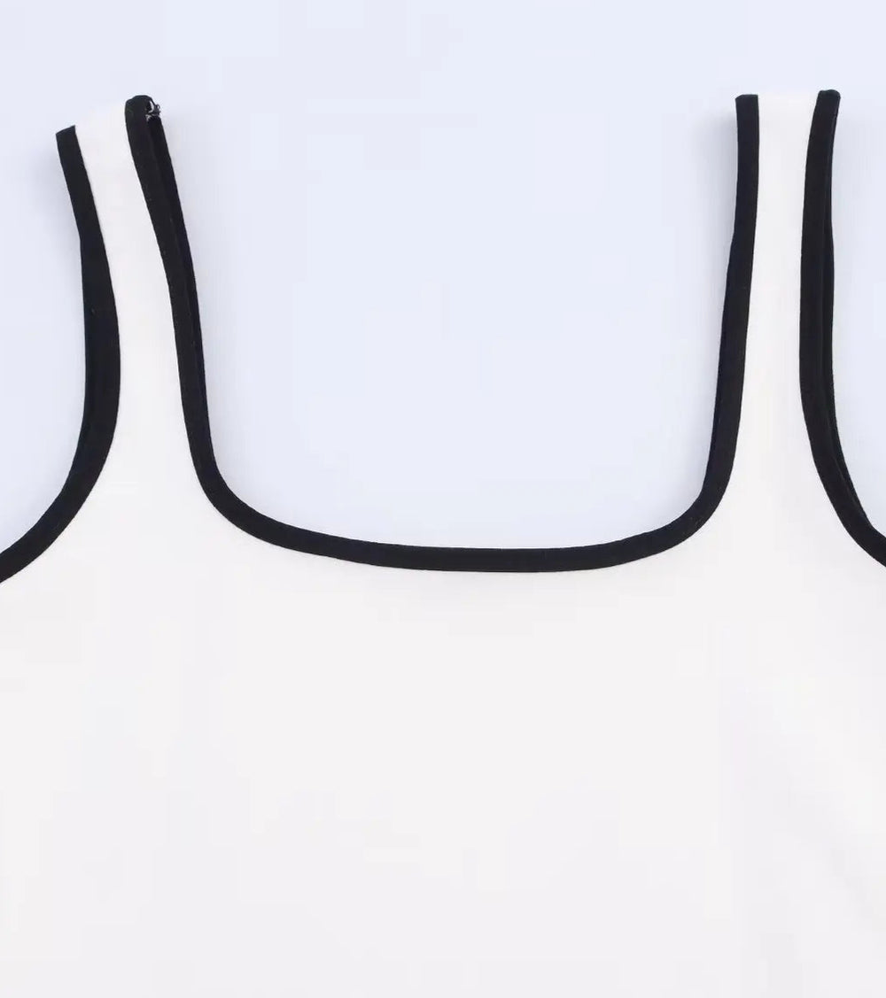 White tank top with black straps on a light gray background