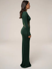 Woman wearing a green long-sleeve dress with sheer panels