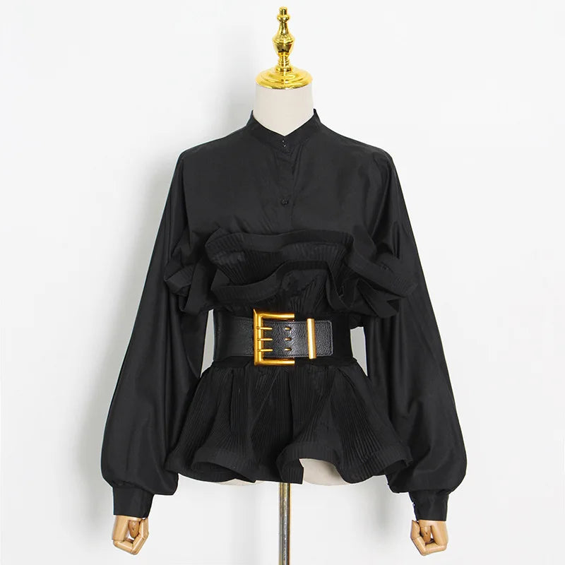 Black blouse with a gold belt on a mannequin against a white background