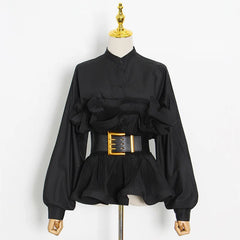 Black blouse with a gold belt on a mannequin against a white background