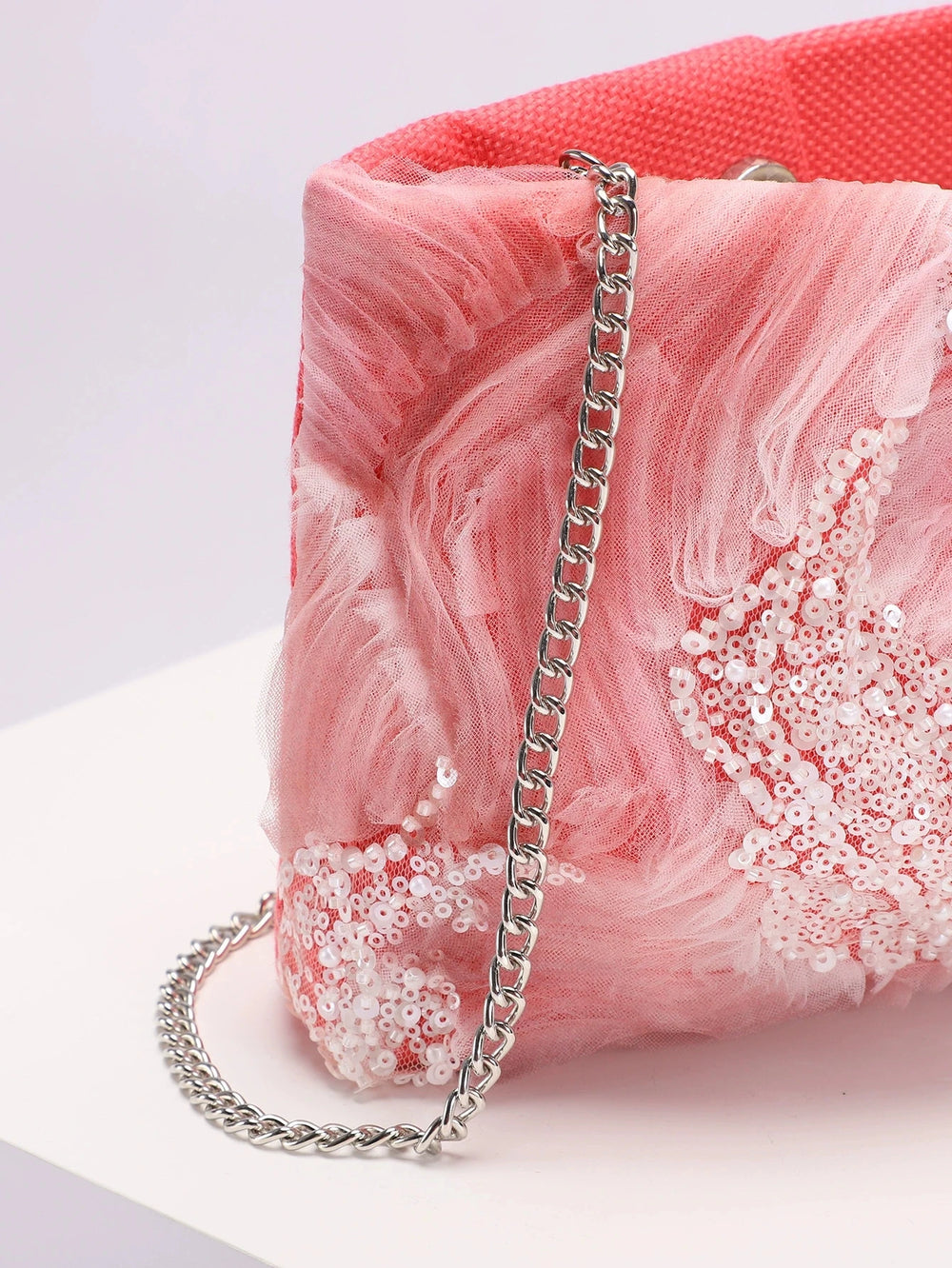 Pink marble handbag with sequins and a chain strap