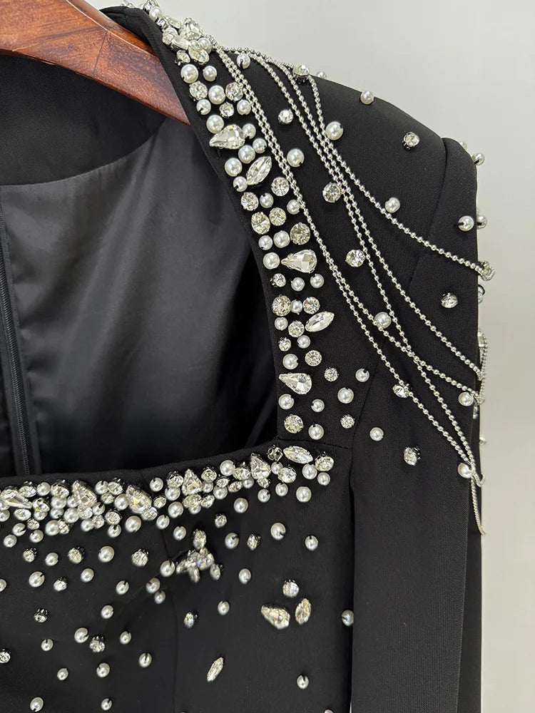 Detail of beaded neckline and shoulders on black dress