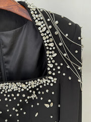 Detail of beaded neckline and shoulders on black dress