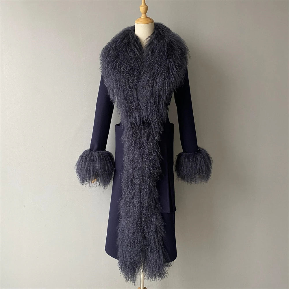 Navy blue coat with fur details on a mannequin against a plain background