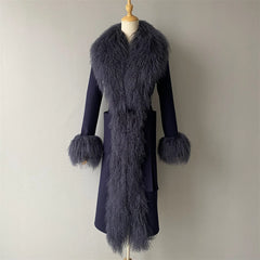 Navy blue coat with fur details on a mannequin against a plain background